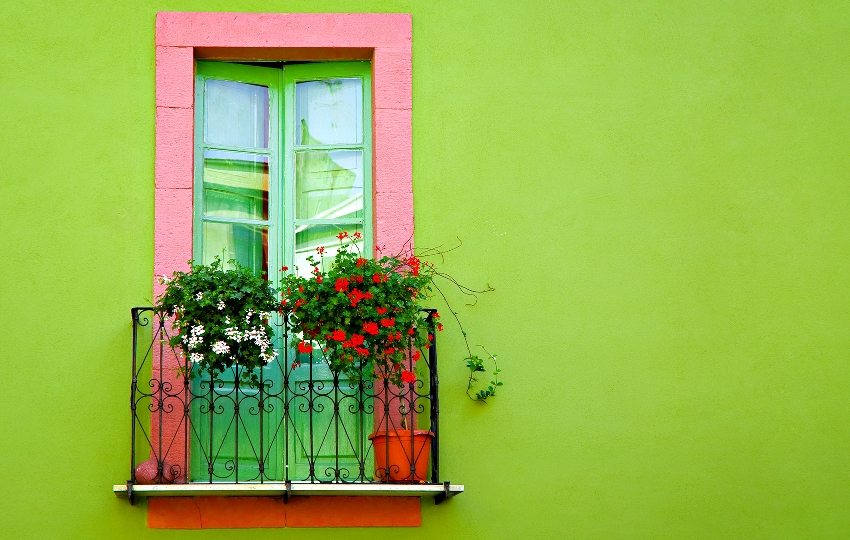 The facade of the house is painted in a bright lime color The facade of the house is painted in a bright lime color