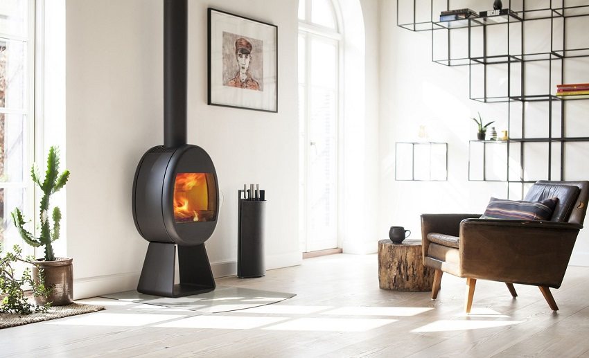 Compact fireplace stove in the living room, decorated in a modern style Compact fireplace stove in the living room, decorated in a modern style