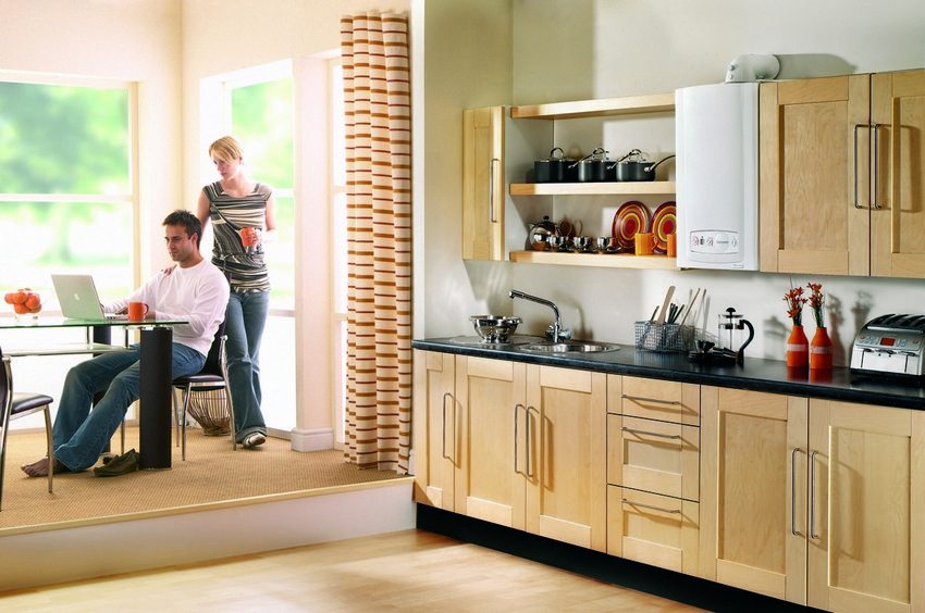 Wall-mounted gas boiler in the interior of the kitchen Wall-mounted gas boiler in the interior of the kitchen