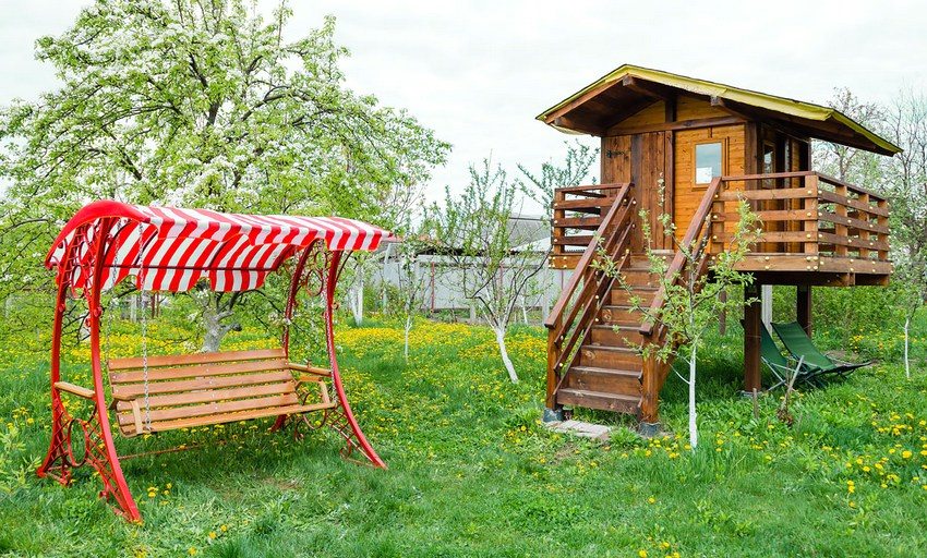 Perhetyyppinen puutarhakeinu metallirungolla ja puisella istuimella Perhetyyppinen puutarhakeinu metallirungolla ja puisella istuimella