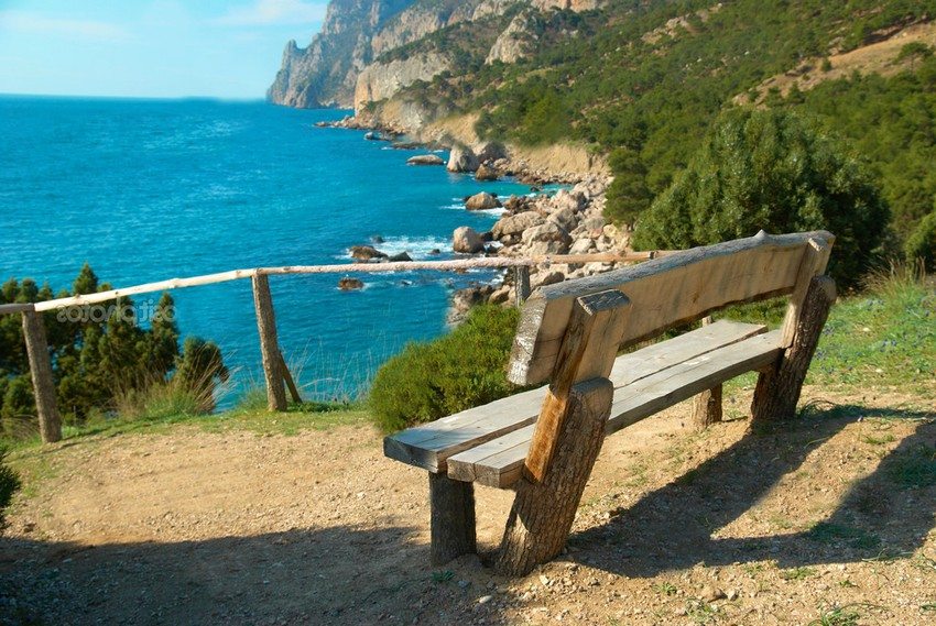 Bench with backrest made of logs and boards Bench with backrest made of logs and boards