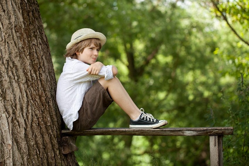 A variant of a simple plank bench attached to a tree in the garden A variant of a simple plank bench attached to a tree in the garden