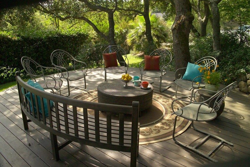 The key link in the patio is a wooden bench with a back The key link in the patio is a wooden bench with a back