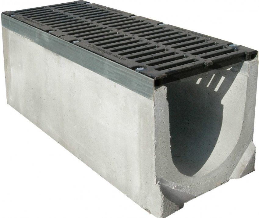 Concrete channel with cast iron grate for storm drainage system Concrete channel with cast iron grate for storm drainage system