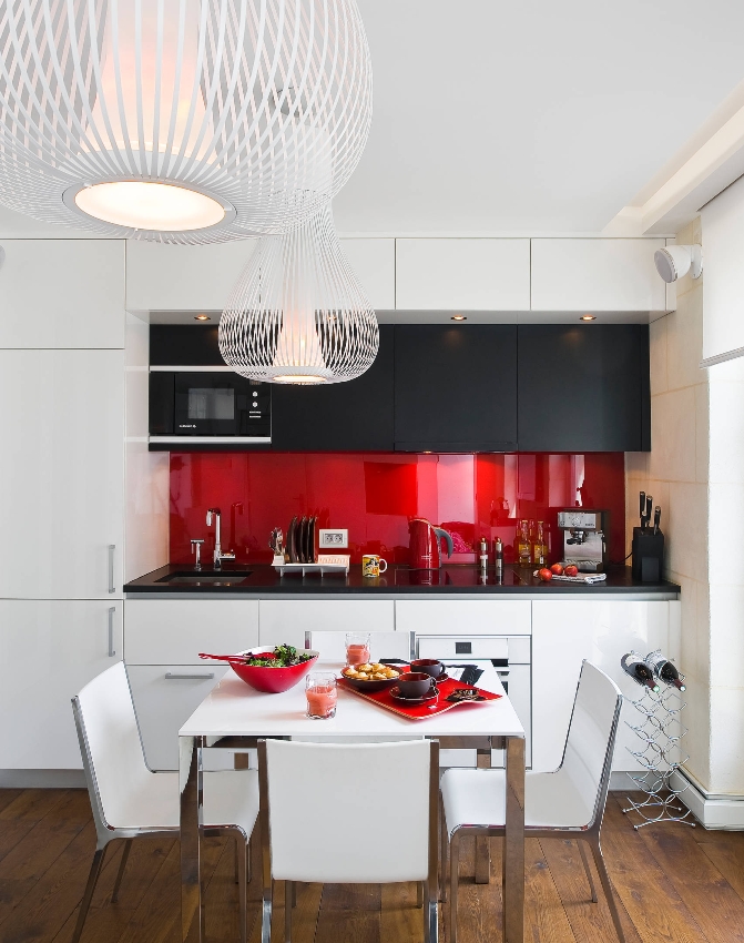 O painel vermelho elegante é capaz de criar um efeito de contraste incomum quando combinado corretamente com móveis de cozinha brancos e pretos O painel vermelho elegante é capaz de criar um efeito de contraste incomum quando combinado corretamente com móveis de cozinha brancos e pretos