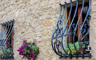 Wrought iron grates on the windows: decoration and reliable protection of the house